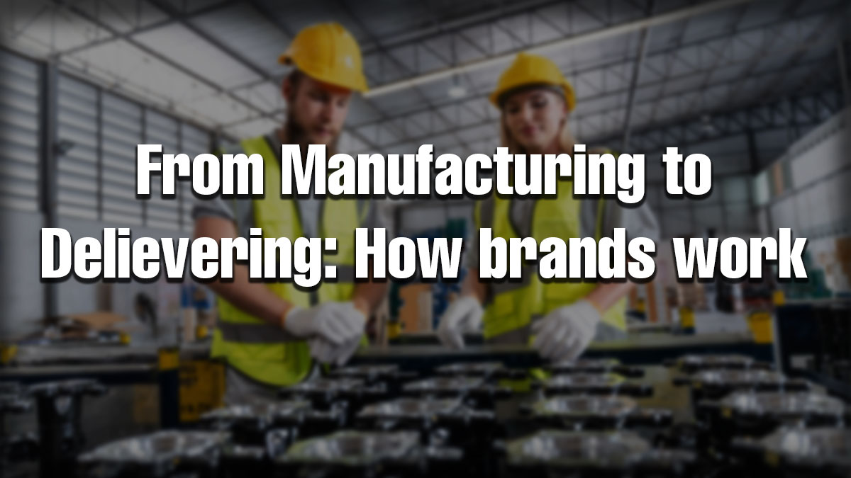 Two factory workers inspecting machinery representing the manufacturing to delivery process in brand operations.